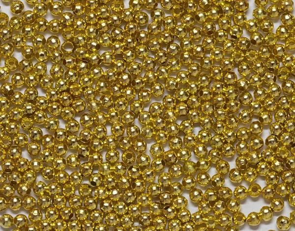 stock image Gold jewelry beads from spilling on white background