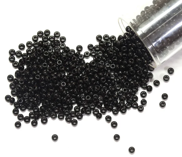 stock image Black beads spilled from a jar