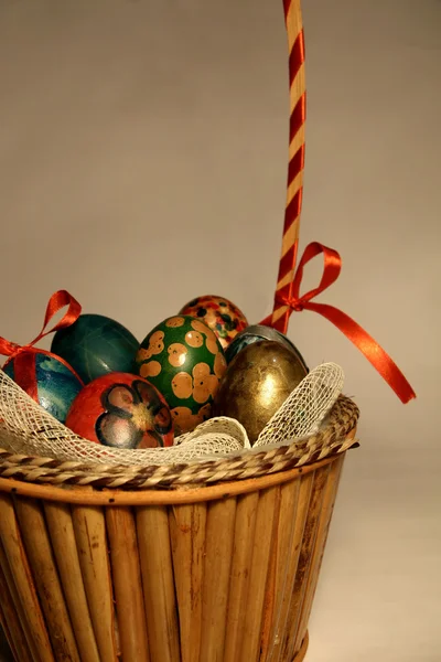 Basket full of colorful eggs — Stock Photo, Image