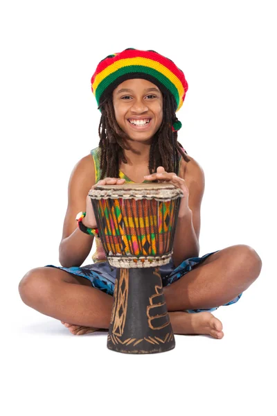 Rasta man sitting on the floor and beat a drum — Stock Photo, Image