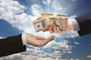 Handing Over Cash with Dramatic Clouds and Sky
