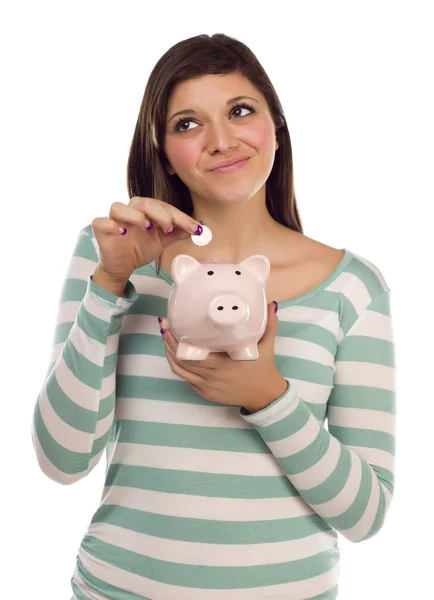 Etnia feminina colocando moeda em Piggy Bank em branco — Fotografia de Stock