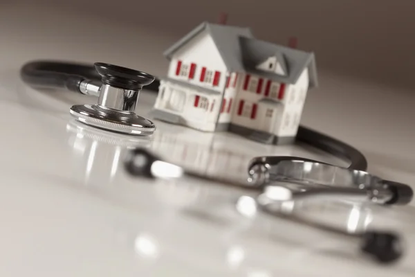 stock image Stethoscope with Small Model Home