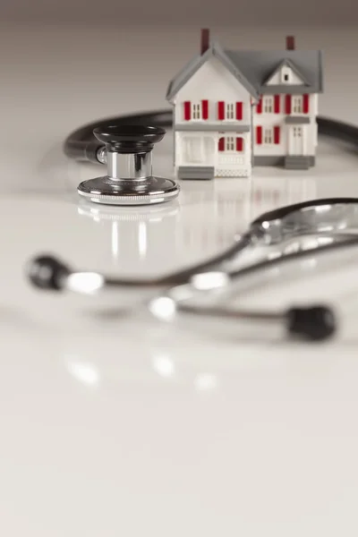 stock image Stethoscope with Small Model Home