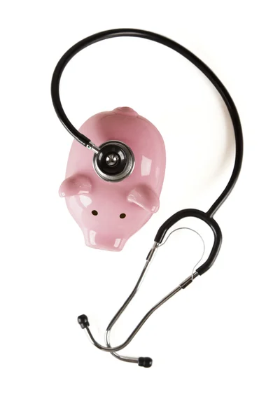 Kumbara ve izole stetoskop — Stok fotoğraf