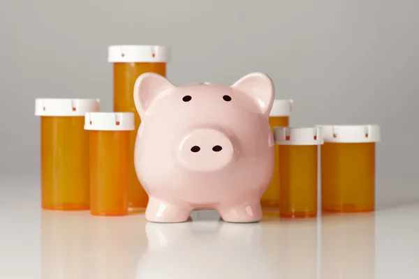 Piggy Bank In Front of Several Medicine Bottles — Stock Photo, Image