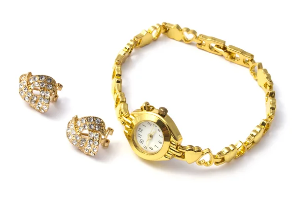 Golden wrist watch and earrings — Stock Photo, Image