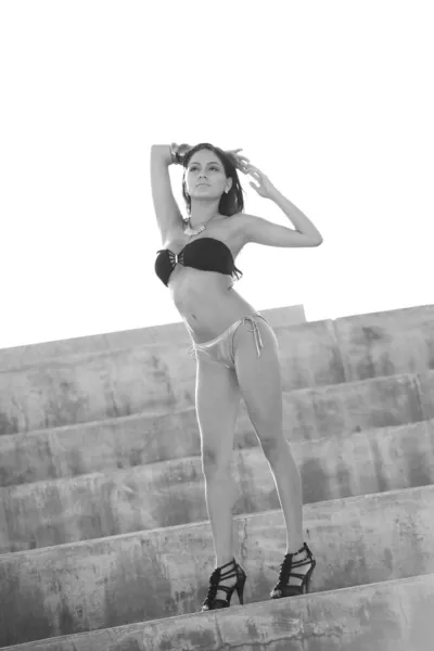 Bikini model posing on concrete steps — Stock Photo, Image