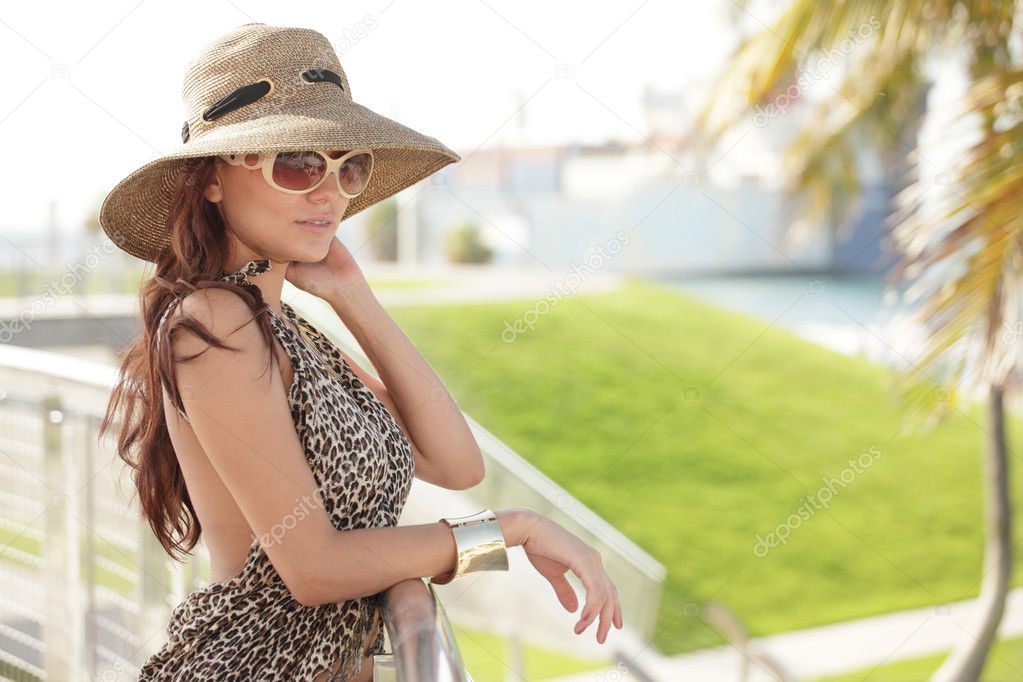 Fashionable woman leaning on a rail