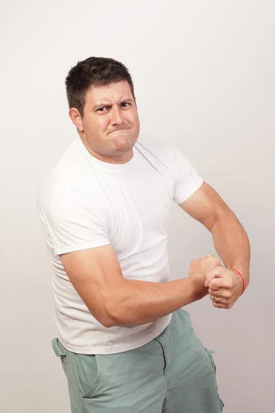 Man flexing his arms — Stock Photo, Image