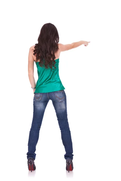 Young casual woman points finger — Stok fotoğraf