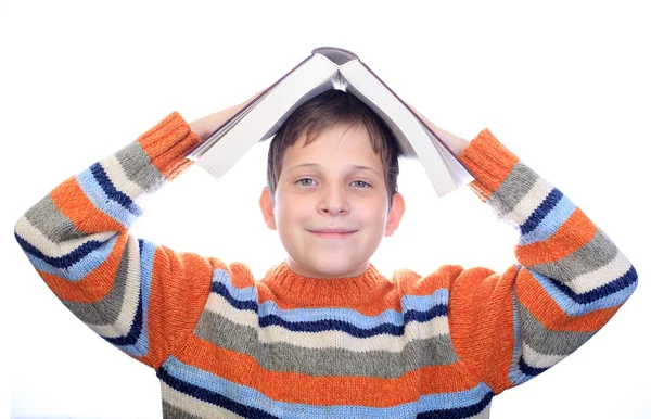Student child with a book on his head — Stock Photo, Image