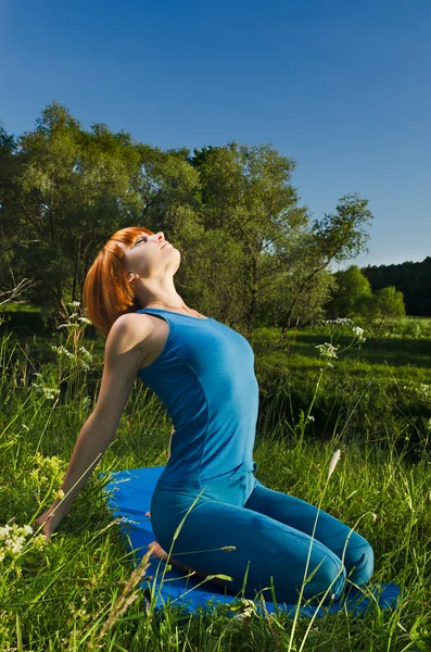 Red woman practicing yoga — Stock Photo, Image