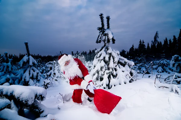 Santa with heavy sack — Stok fotoğraf