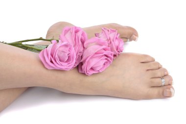 Female feet with flowers isolated over white background clipart