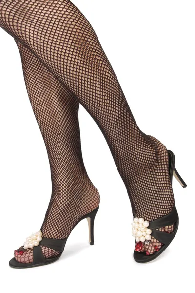 Frau Beine tragen High Heels über weißem Hintergrund — Stockfoto