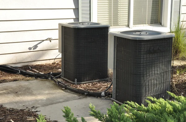 Two outdoor central air conditioner units Royalty Free Stock Images