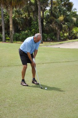 Man putting on a golf course clipart