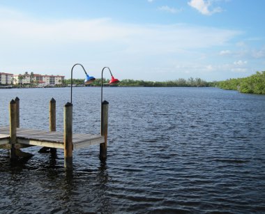 Old wooden boat dock by an inlet in Naples Florida clipart