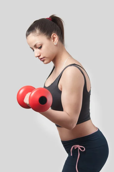 Strong attractive girl exercising with weights. — Stock Photo, Image