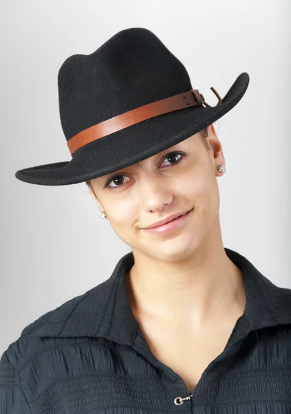 Portrait of the beautiful teenage girl wearing black cowboy hat. — Stock Photo, Image