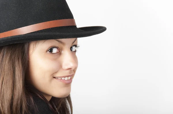 Portrait of the beautiful smiling teenage girl wearing black cowboy hat. — Stock Photo, Image