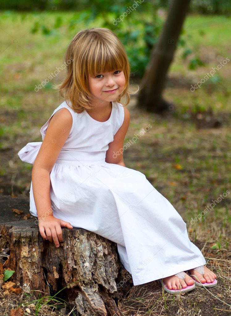 Beautiful little girl smiles while posing outside — Stock Photo ...