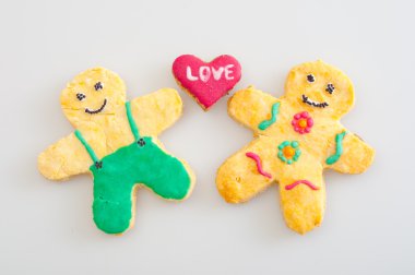 Beautifully decorated cookies representing love between man and women clipart