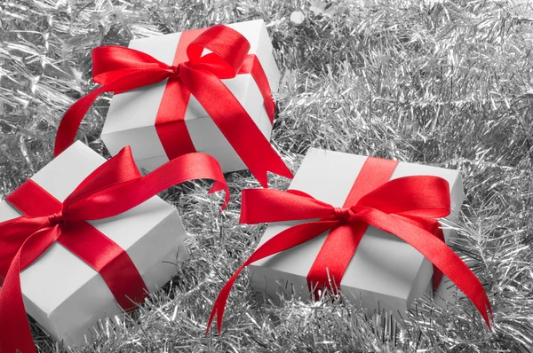 stock image Christmas gifts on the bed made of soft silver decorations