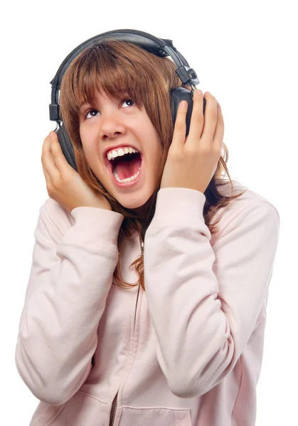 Beautiful teenage girls sings while listening music through headphones — Stock Photo, Image