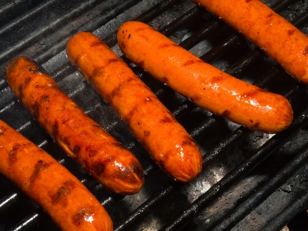 stock image A row of five hotdogs on a bbq grill