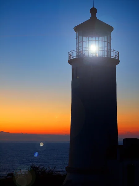 stock image Light Shining in the North Head Lighthouse on the Washington Coast at Sunse