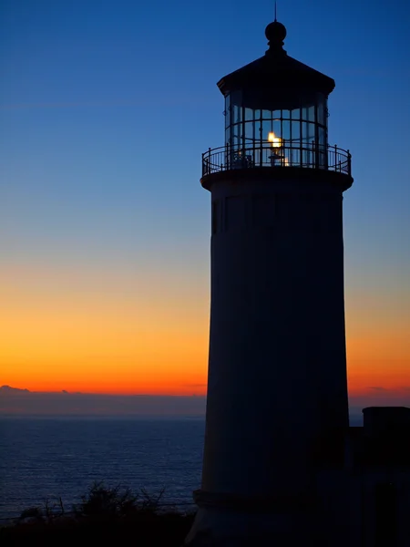 stock image Light Shining in the North Head Lighthouse on the Washington Coast at Sunse