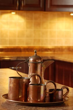 Old copper in kitchen focus on jug clipart