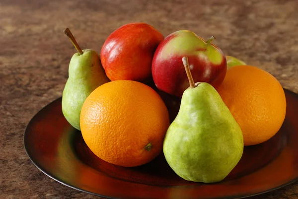 Closeup fruit on a wooden plate — Stock Photo, Image