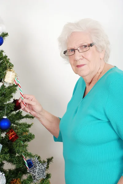 Senior woman stealing candy cane — Stock Photo, Image