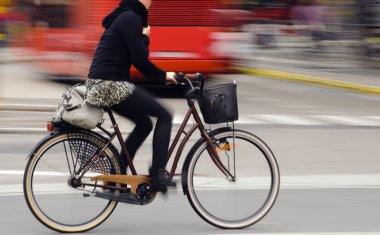 Biker in city traffic clipart