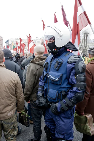 Riot policeman in crowd — Stock Photo, Image