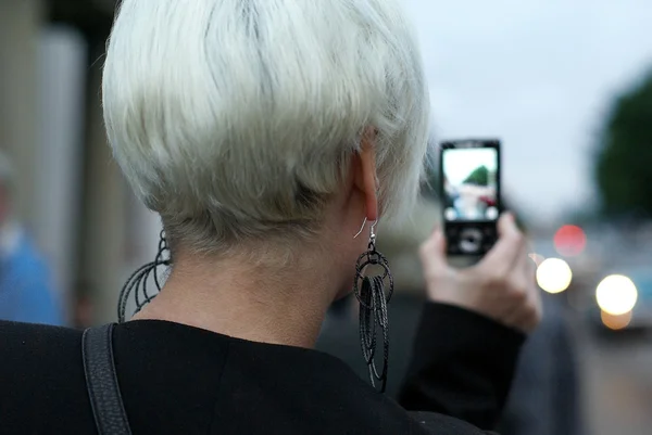 stock image Woman taking picture with cell phone