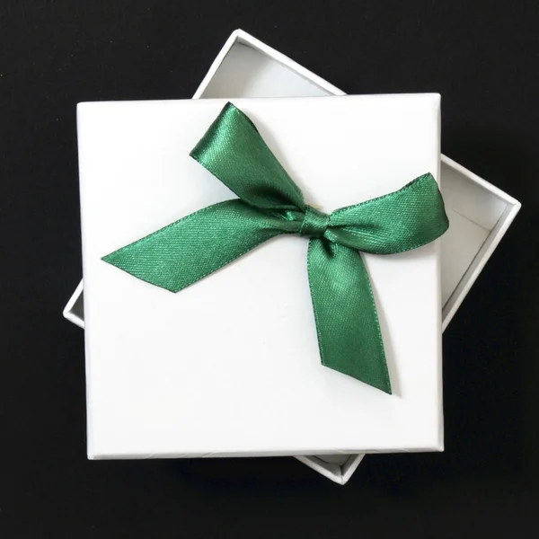 Белый подарок с зеленой лентой — стоковое фото