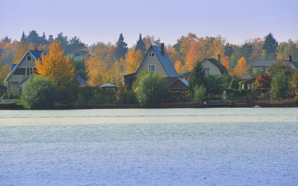 stock image Village in autumn lake