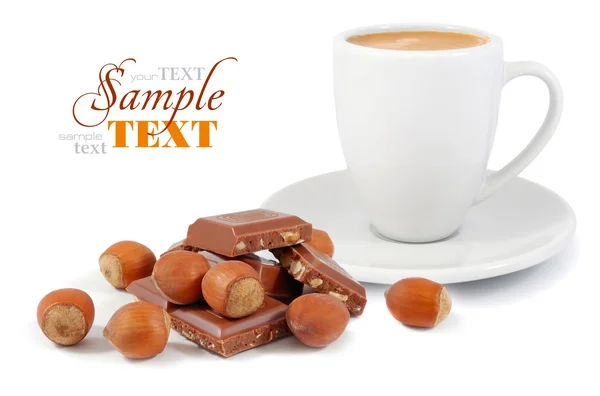 A cup of coffee with a chocolate and nuts on a white background — Stock Photo, Image