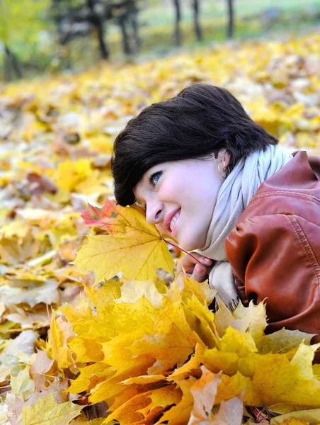 Girl in autumn with maple leaves — Stock Photo, Image