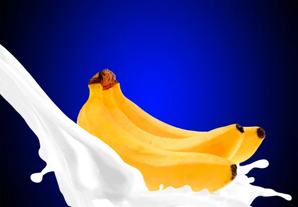 Splashing milk with banana — Stock Photo, Image