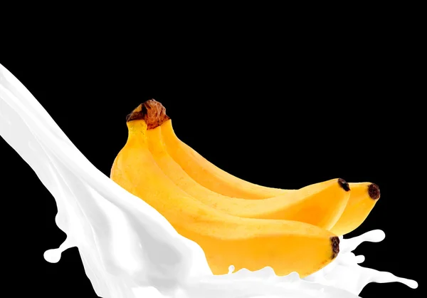 Splashing milk with banana — Stock Photo, Image