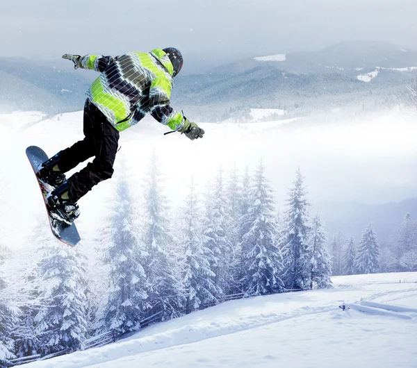 Snowboarder skacząc w powietrzu z głębokim błękitnym niebem w tle — Zdjęcie stockowe