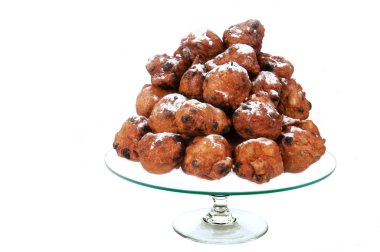 Dutch traditional oliebollen on glass-plate clipart