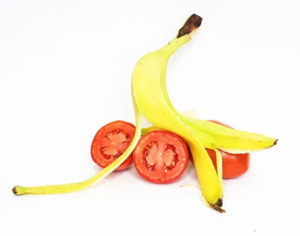 Banana skin and tomatoes insulated on white background — Stock Photo, Image