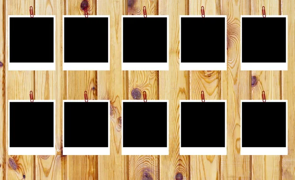 Set of ten old blank polaroids frames lying on a wood surface — Stock Photo, Image