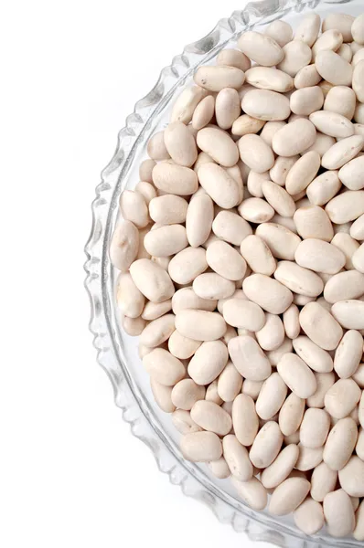 Haricot fazole v skleněnou desku izolovaných na bílém pozadí — Stock fotografie